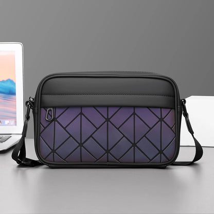 Black and purple geometric-patterned bag on a gray surface with a laptop in the background