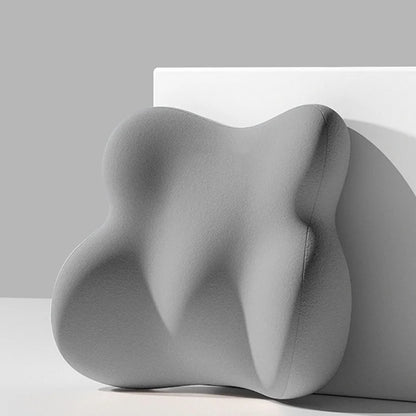 Gray abstract sculpture on a white surface with a gray background