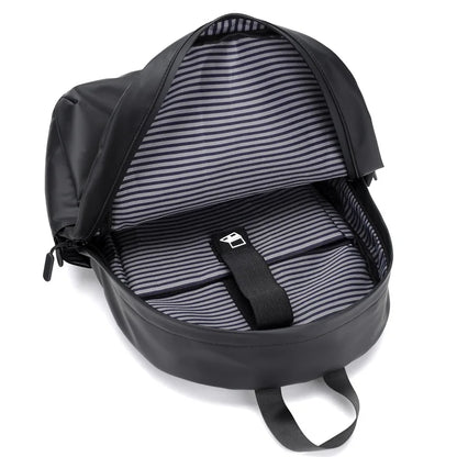 Interior view of a spacious black backpack with striped lining and dedicated laptop compartment.