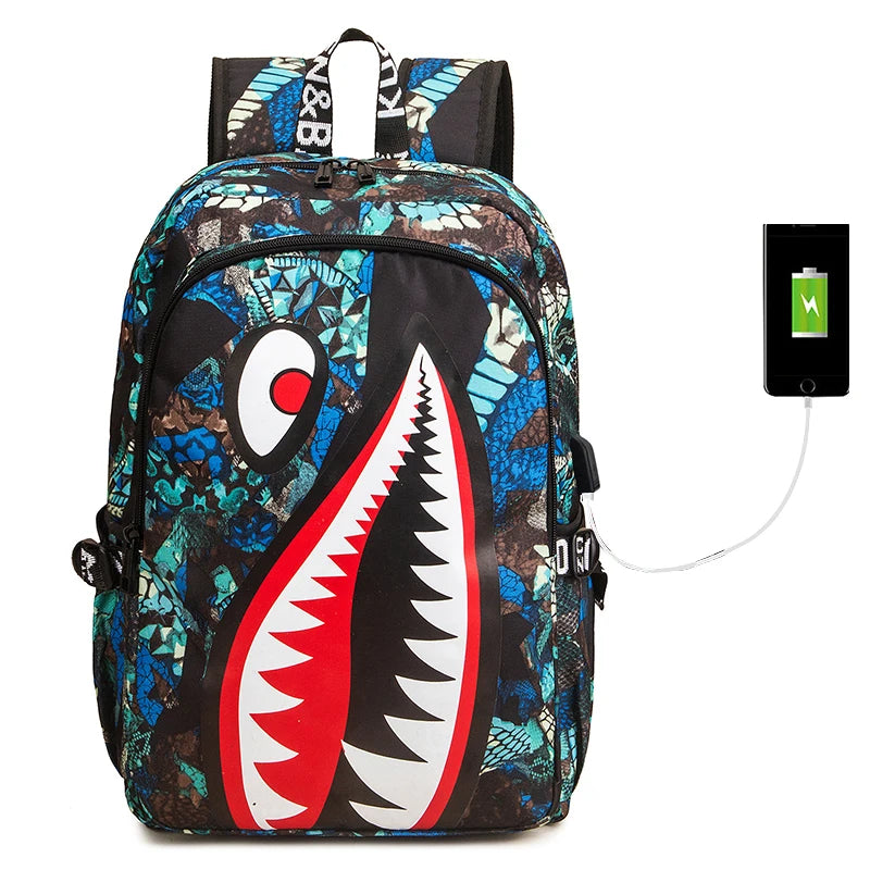 Backpack with shark mouth design and USB cable on a white background