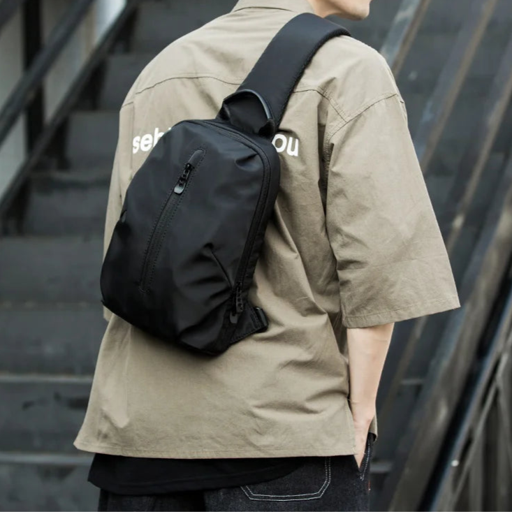 Person wearing a black backpack on a staircase