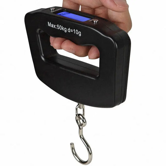 Digital luggage scale held by a hand with a white background
