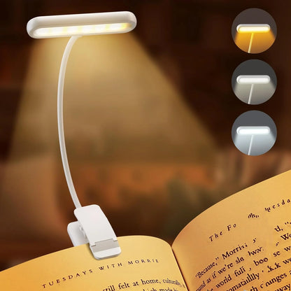 Clip-on book light with adjustable arm on an open book, showing three brightness settings.