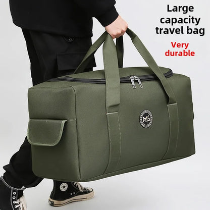 Green travel bag with a visible brand logo, held by a person on a light gray background.