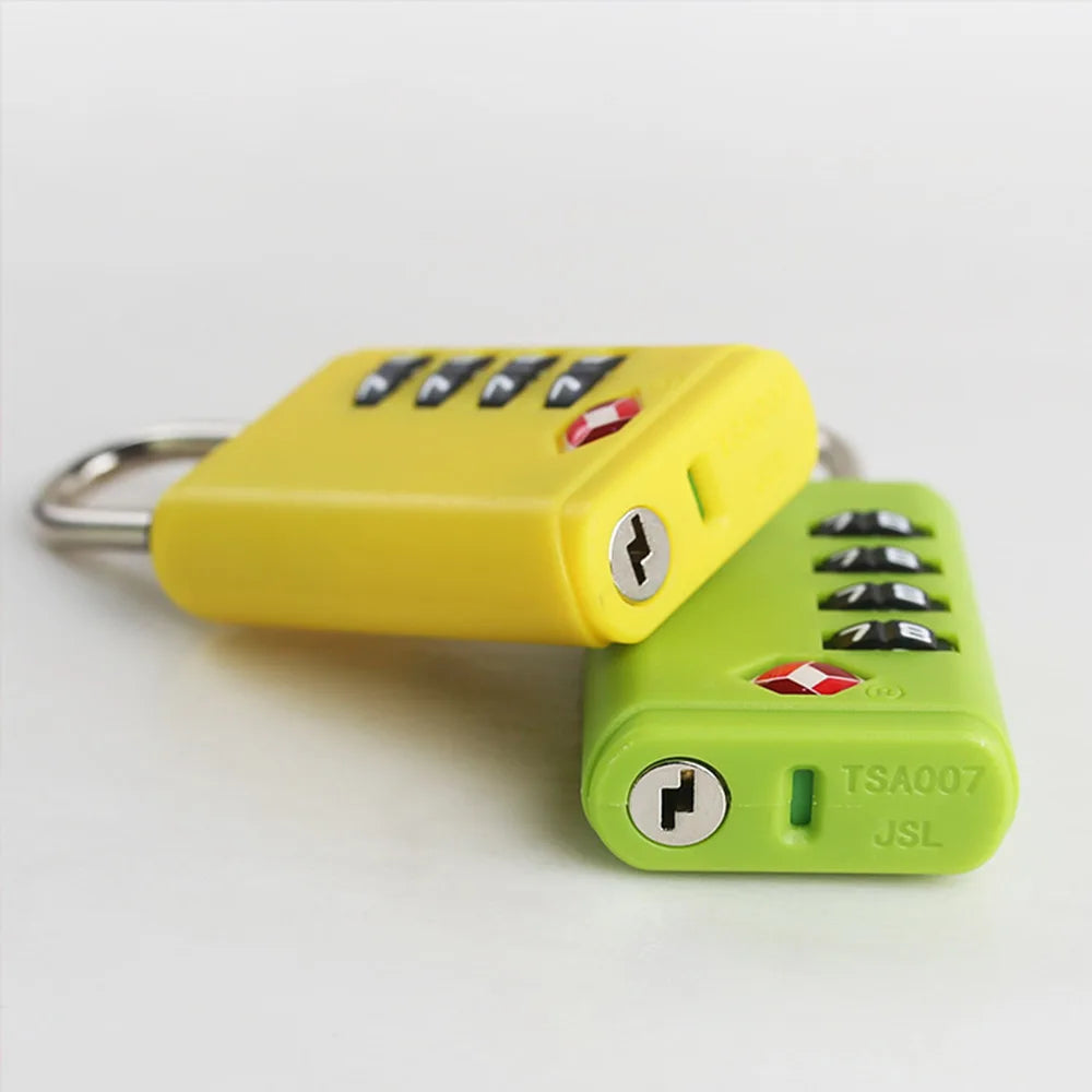 Two TSA-approved luggage locks, one yellow and one green, on a light gray background.