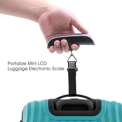 Hand holding a portable mini LCD luggage electronic scale above a teal suitcase.