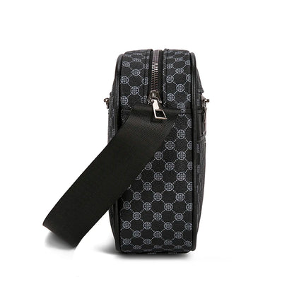 Black patterned crossbody bag with a strap on a white background