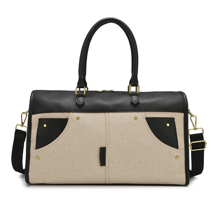 Black and beige handbag with gold accents on a white background