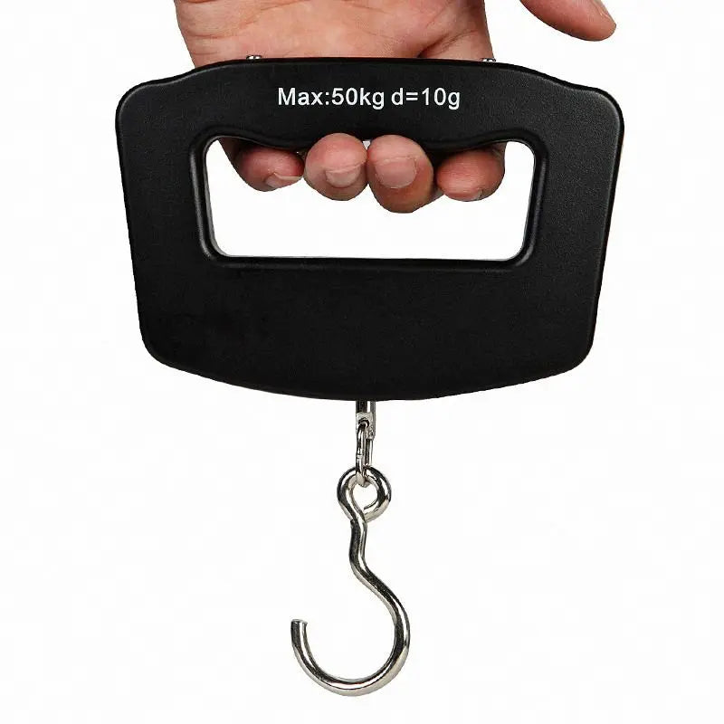Hand holding a black digital luggage scale with a metal hook on a white background