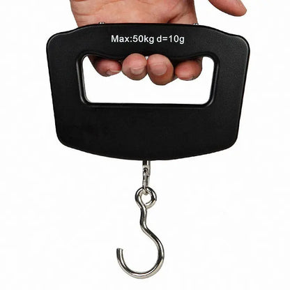 Hand holding a black digital luggage scale with a metal hook on a white background