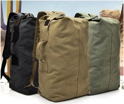 Three canvas bags in black, brown, and green on a white surface with a blurred background.