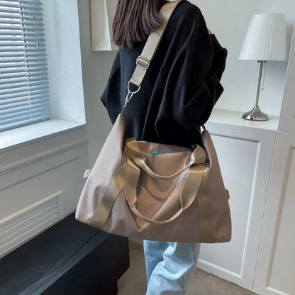Person holding a gold handbag in a room with a window and lamp.