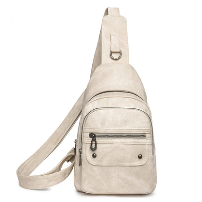 Beige sling bag with multiple pockets on a white background