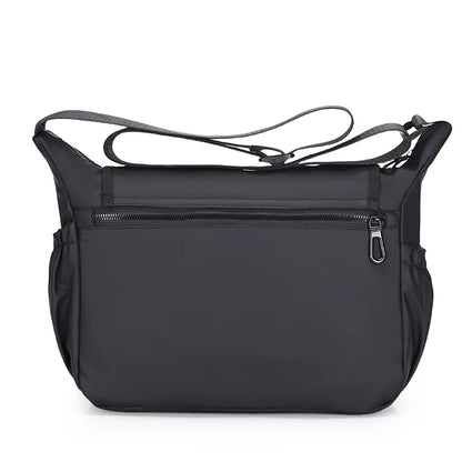 Black shoulder bag with a strap on a white background