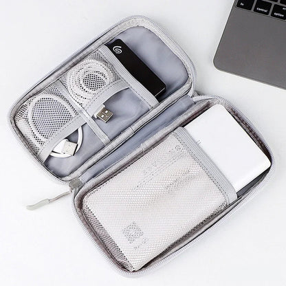 Open travel organizer with electronic devices on a white background
