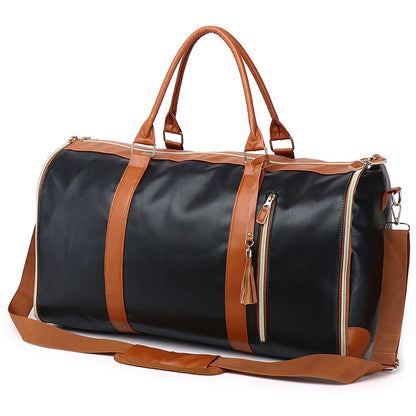 Black duffel bag with brown leather straps and accents on a white background