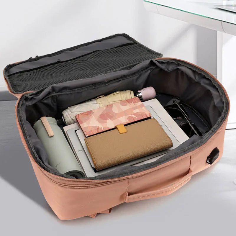 Open suitcase with travel items on a light background