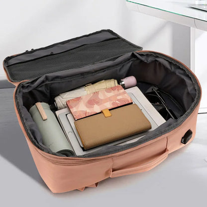 Open suitcase with travel items on a light background