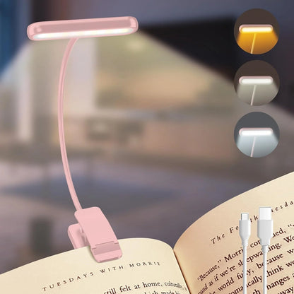 Pink booklight on an open book with three light mode indicators above it.