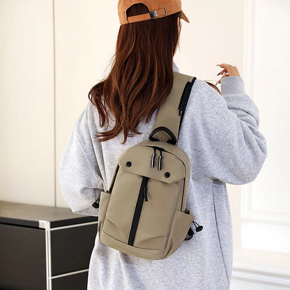 Person wearing a beige backpack and brown cap indoors