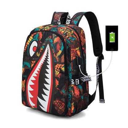Colorful backpack with shark mouth design and charging cable, on a white background