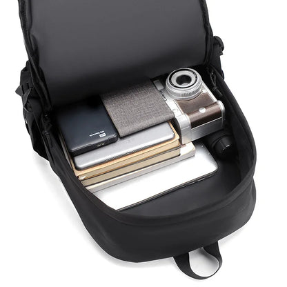 Black backpack with compartments containing a camera, phone, and books on a white background