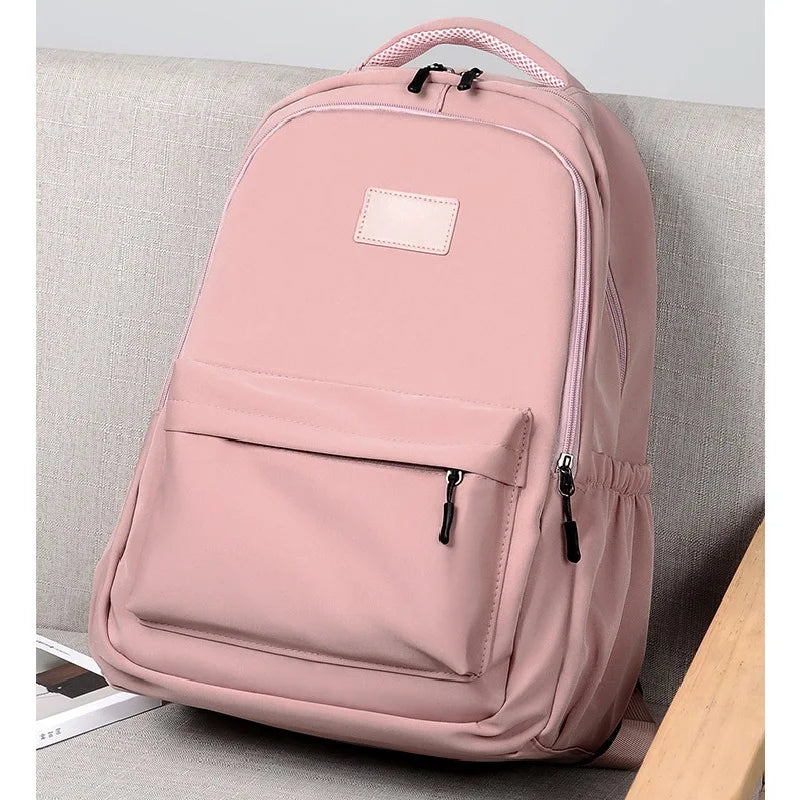 Pink backpack on a light gray couch