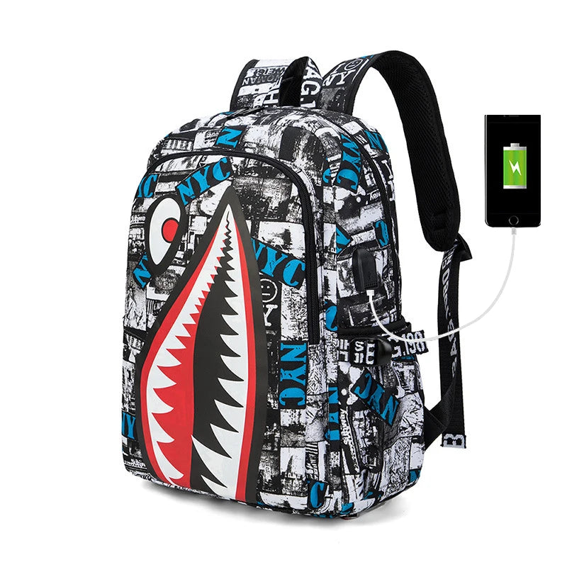 Backpack with shark mouth design and charging cable, on a white background