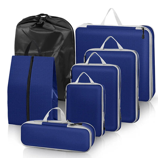 Set of blue packing cubes with black drawstring bag on a white background