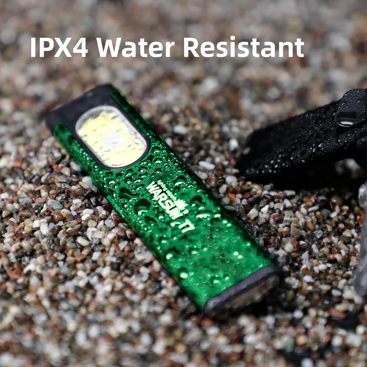 Green flashlight on sand with 'IPX4 Water Resistant' text