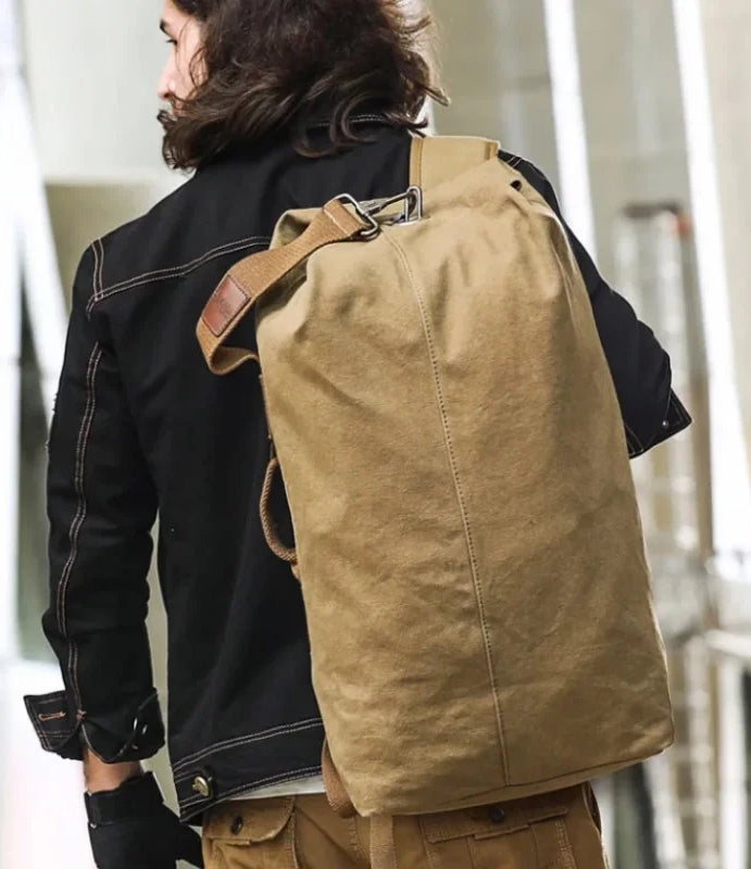 Person wearing a brown backpack with a blurred background
