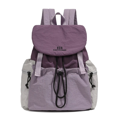 Purple and gray backpack with North Face logo on a white background