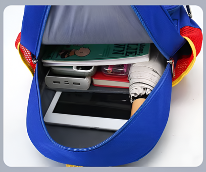 Blue backpack with items like a tablet, notebook, and watch inside on a white background
