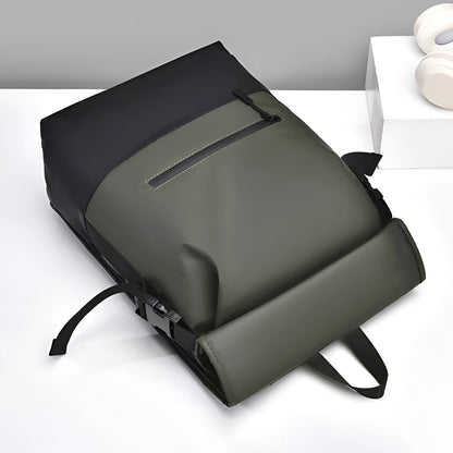 Green backpack on a white surface with a gray background