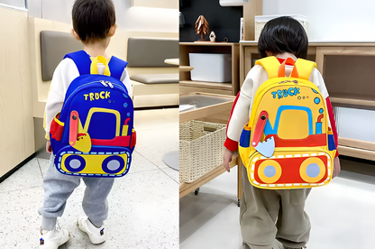Two children wearing colorful backpacks with a truck design in a home setting.