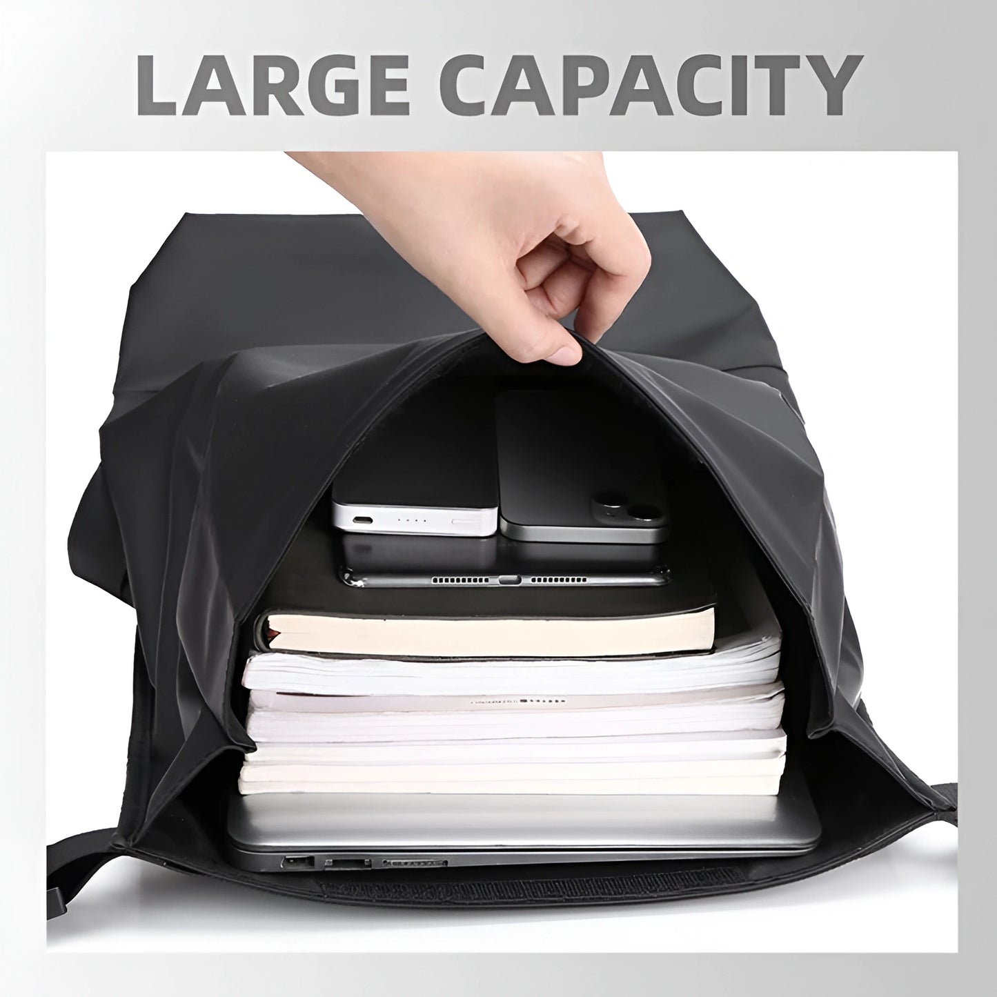 Black backpack with large capacity filled with books, a laptop, and electronic devices.