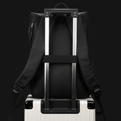 Black backpack on a white suitcase against a black background