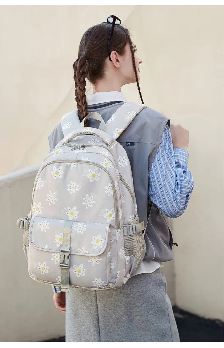 Person wearing a floral backpack with a plain background