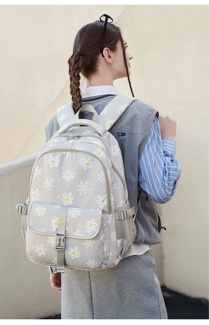 Person wearing a floral backpack with a plain background