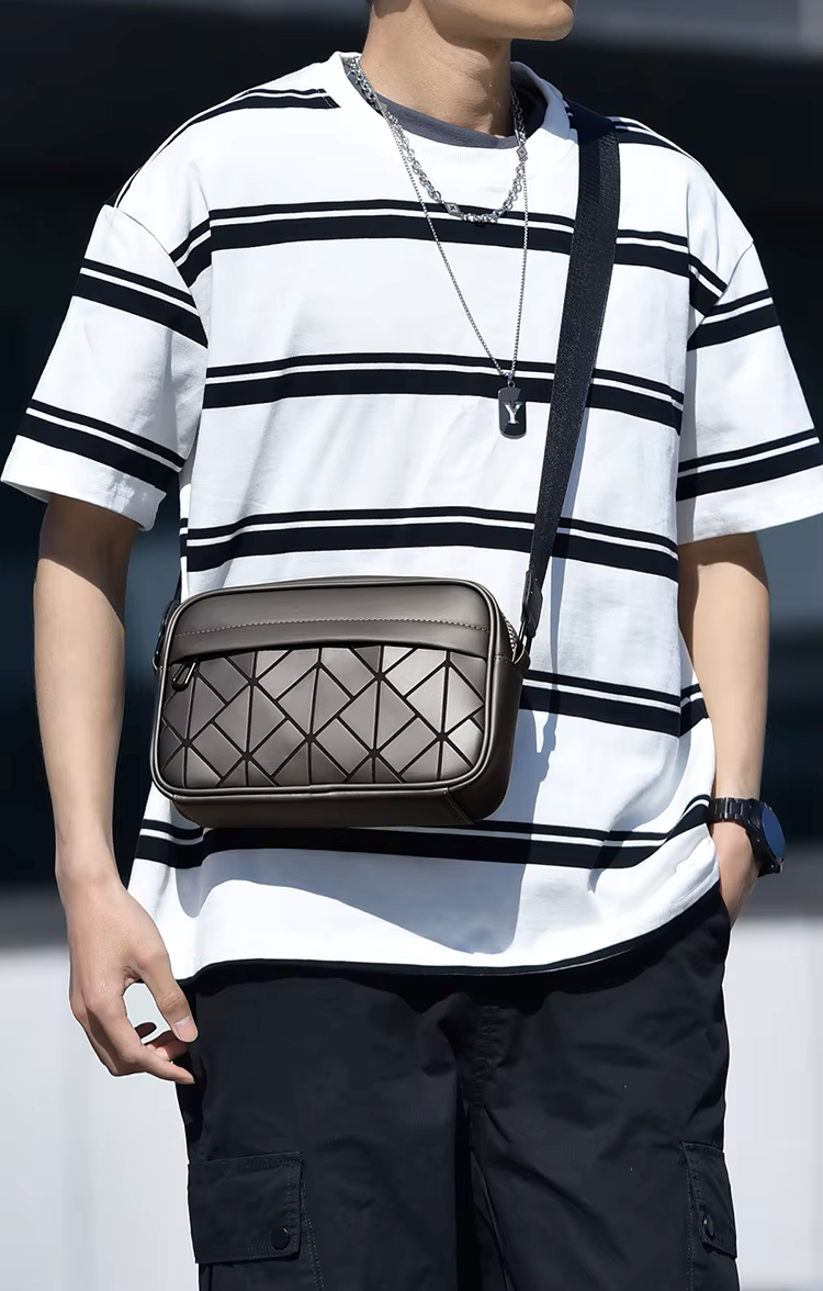 Person wearing a white and black striped shirt with a brown geometric-patterned bag.