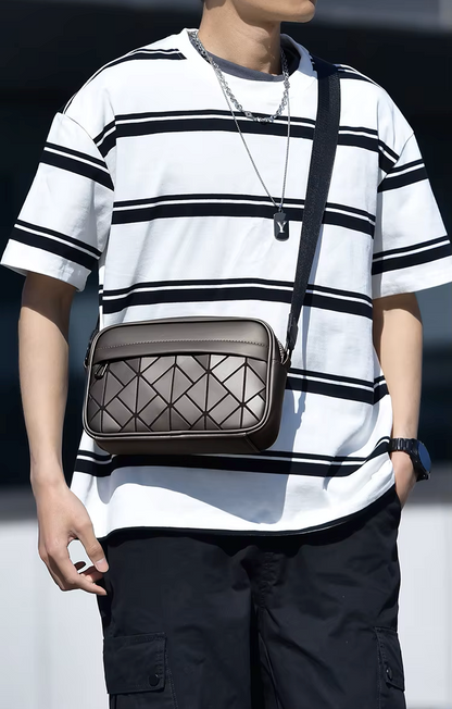 Person wearing a white and black striped shirt with a brown geometric-patterned bag.