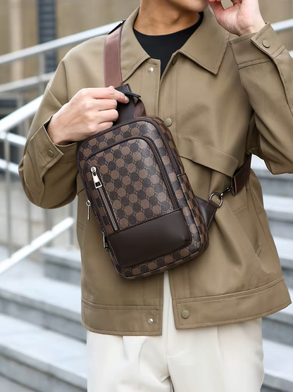 Person wearing a brown patterned crossbody bag outdoors