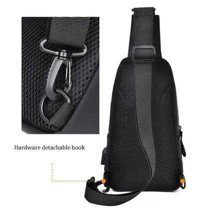 Black sling bag with detachable hook feature on a white background