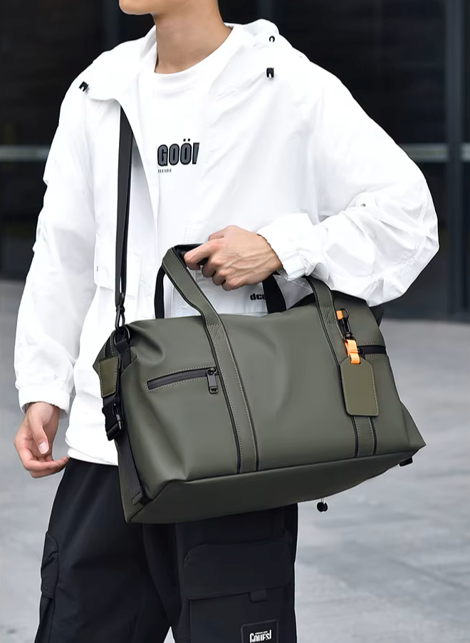 Person holding a green duffel bag with a blurred background