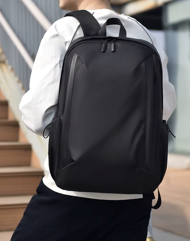 Person wearing a black backpack outdoors on a staircase