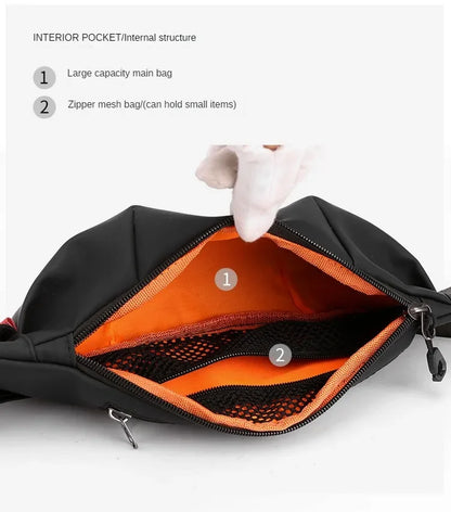 Black bag interior with orange mesh pocket and large capacity main bag, held open by a gloved hand.