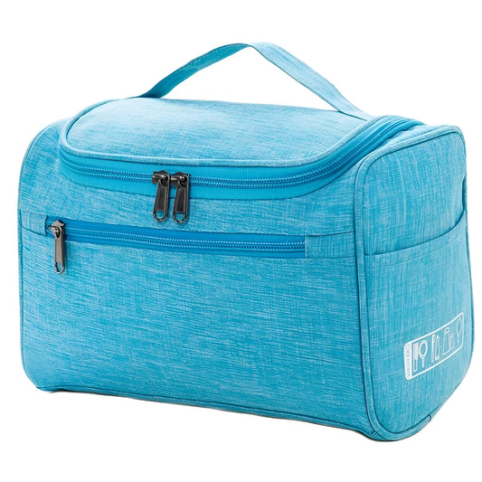 Blue toiletry bag with a handle on a white background
