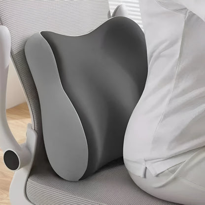 Gray ergonomic pillow on a chair with a person sitting back