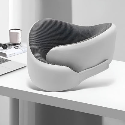 Modern gray and white office chair on a white desk with minimal decor.
