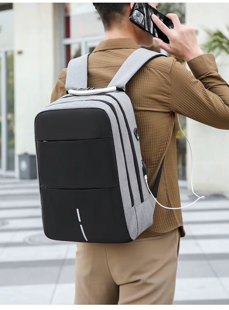 Person wearing a black and gray backpack with earphones, walking outdoors.